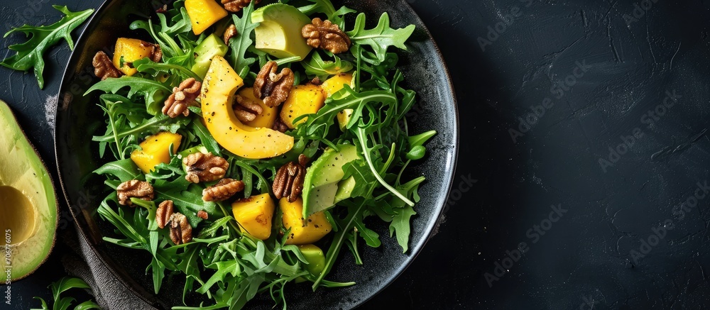 Poster Salad with mango avocado arugula and walnuts. with copy space image. Place for adding text or design