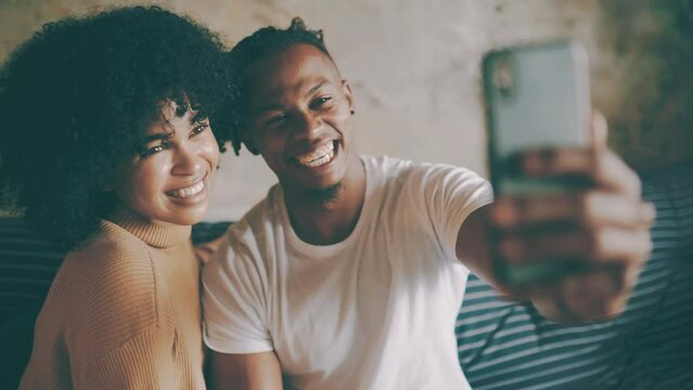 Couple, selfie and smiling for social media post on technology, smartphone and relaxing on couch. Living room, black people and picture for blog update at home, happy and mobile application or web