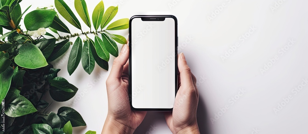 Poster The hand holding the phone with a white background In the concept of online business communication. with copy space image. Place for adding text or design