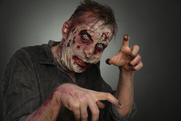 Scary zombie on dark background. Halloween monster