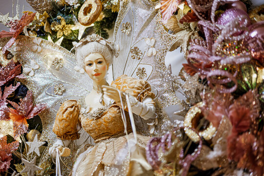 christmas golden fairy decoration with pink and gold flowers, sybol of good wishes coming true
