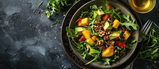 Salad with mango avocado arugula and walnuts. with copy space image. Place for adding text or design