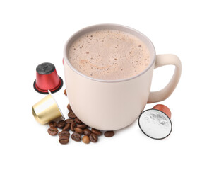 Cup of coffee, capsules and beans isolated on white