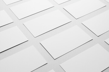 Fototapeta premium Blank business cards on light gray background, closeup. Mockup for design