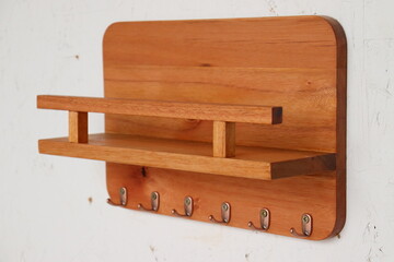 Support for storing things with key hanger, made with wood and a natural finish.