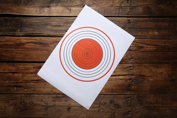 Shooting target on wooden table, top view