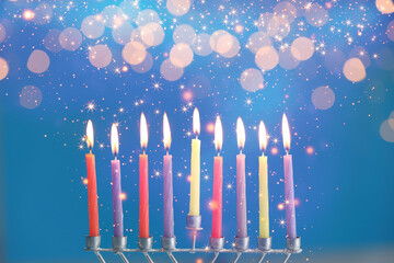 Hanukkah celebration. Menorah with burning candles on blue background with blurred lights, closeup