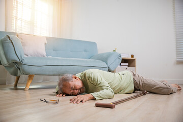 Elder man falling on the floor alone with walking stick on living room at home, Older senior man...