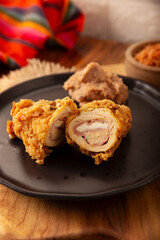 Chicken Cordon Bleu. Chicken breast meat wrapped with ham and cheese, breaded and fried or baked. Also known as schnitzel cordon bleu, a very popular recipe in many countries.