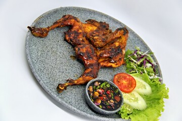 Bakakak Hayam or Ayam Bekakak or Grilled Whole Chicken with seasonings plus soy sauce, a dish from West Java and Jakarta, Indonesia. Usually served to brides at weddings.