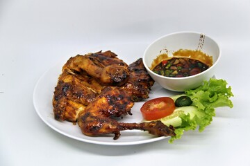 Bakakak Hayam or Ayam Bekakak or Grilled Whole Chicken with seasonings plus soy sauce, a dish from West Java and Jakarta, Indonesia. Usually served to brides at weddings.
