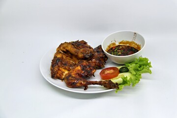 Bakakak Hayam or Ayam Bekakak or Grilled Whole Chicken with seasonings plus soy sauce, a dish from West Java and Jakarta, Indonesia. Usually served to brides at weddings.