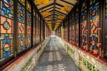 Guangzhou city, Guangdong, China. Lingnan Impression Garden integrates sightseeing, leisure, entertainment, accommodation and experiencing Lingnan local and folk customs. Stained glass corridor.