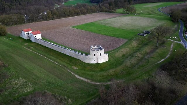 Drone flying around ruins of roman camp during daytime