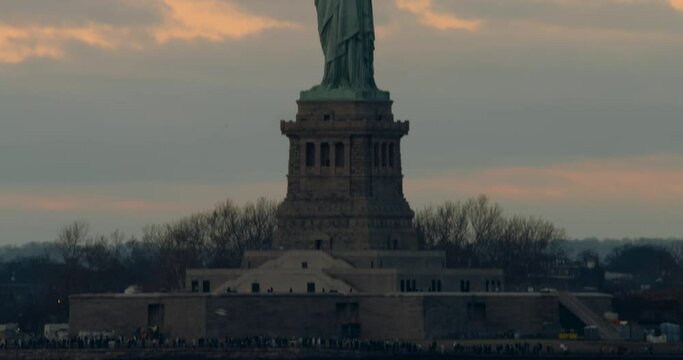 Tilt Up from Liberty Island to Statue of Liberty at Sunset, Center-framed
