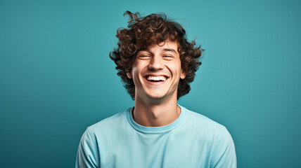 Obraz premium Happy smiling young adult man on a solid background