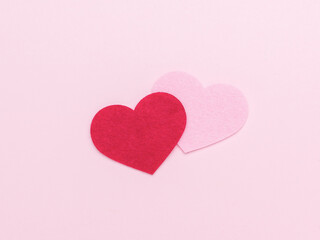 A pink and red heart in the center of a light pink background.