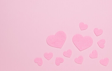 Big and small pink hearts on a light pink background.