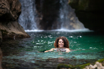Serene Mid Adult Woman Swimming in Cold River Waters in Mountain Wilderness as part of Therapy