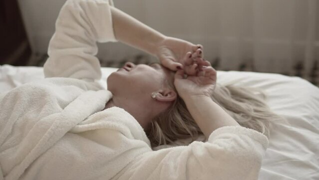 Beautiful Woman Waking Up in the Bed
