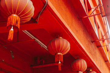 Several Chinese lanterns on the background of the red façade of the building