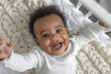 Joyful black infant baby laughing in crib