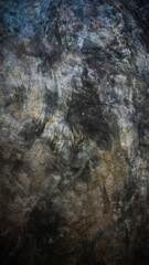 Dark-colored bare cement with a marble-like pattern.