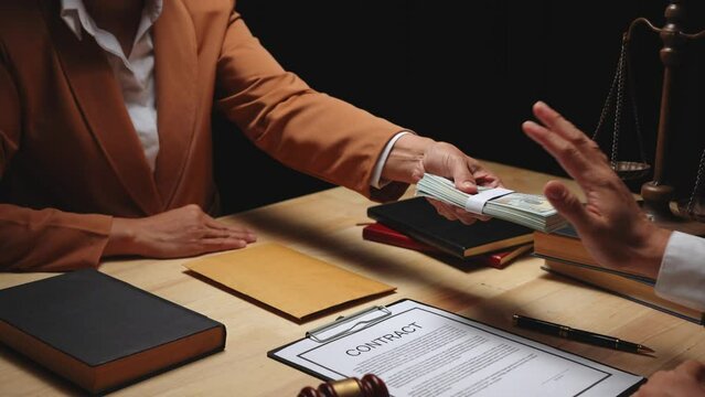 Businesswomen offer bribes to lawyers To help with legal matters in court, bribes corruption illegal fraud bribery concept.