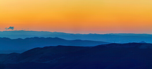Layers of Mountains in Panorama at sunrise, sunset
