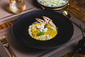 Khanom Jeen, food that has noodles as the main ingredient. Crab meat noodles on a black dinner...