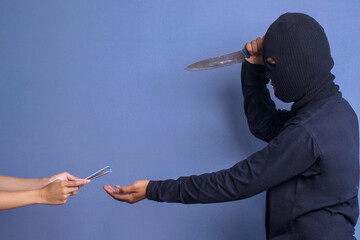 Man burglar wear balaclava threatening with knife and asking money from the victim