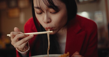Woman, ramen and eating noodles in restaurant for nutrition, healthy meal and diet. Hungry lady,...
