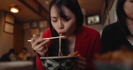 Woman, restaurant and eating ramen noodles for nutrition, gourmet dining or meal with friends....