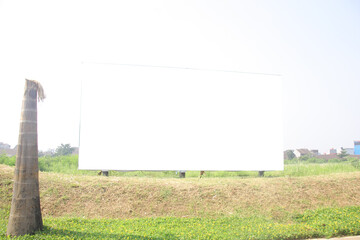 Obraz premium White long horizontal billboard screen on grass field at summer
