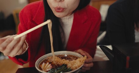 Woman, mouth and blowing ramen noodles in restaurant for dinner, diet and meal in cafeteria....