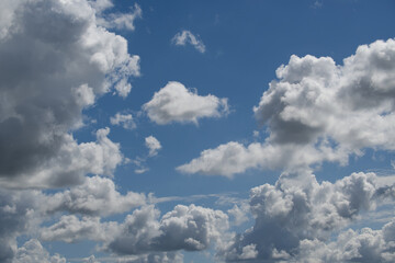 Blue sky with cumulus clouds illuminated by daylight