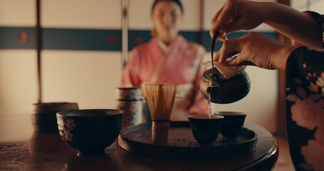 Woman pouring traditional Japanese tea with kimono, teapot and relax with mindfulness, respect and...