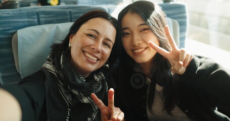 Women, peace sign and selfie on train, portrait and japan public transportation on metro bullet....