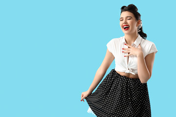 Attractive pin-up woman on blue background