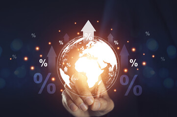 Businessman holding globe and rising interest rates Conceptual image of the problem of high...