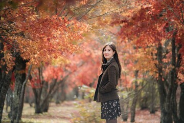 Portrait of a young Asian woman with autumn leaves