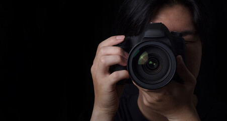 photographer take pictures Snapshot with camera. man hand holding with camera looking through...