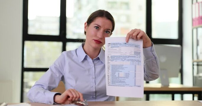 Female worker shows forged documents and handcuffs in office