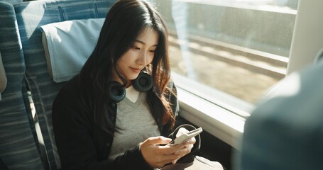 Japan woman, travel and train on smartphone, social media and public transportation on metro bullet. Person, cellphone and online on fast vehicle for weekend trip and commute in tokyo for adventure - obrazy, fototapety, plakaty
