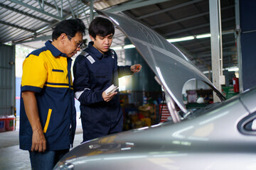 Senior professional repairman inspecting an oil engine in an old car.