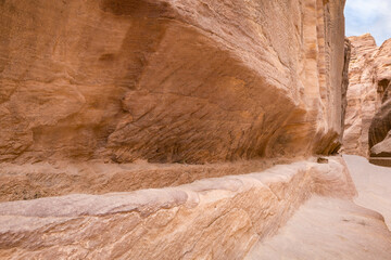 A drainage channel is cut into the wall in continuation of the entire gorge Al Siq in the Nabatean...