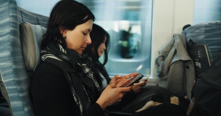 Women, reading and train by smartphone on social media and public transport on metro bullet in japan. Friends, cellphone or diversity on fast vehicle on weekend trip or commute in tokyo on adventure