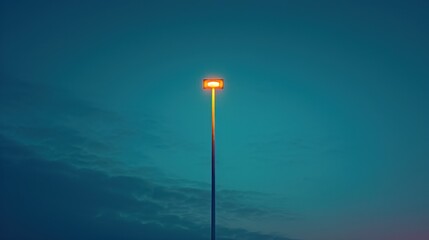 Single street lamp against a gradient evening sky.