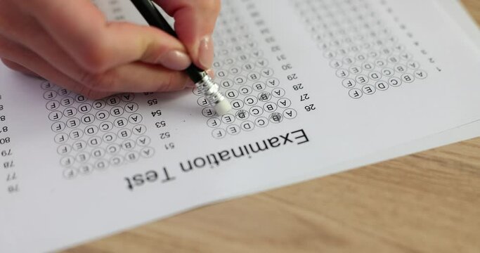 Student erases wrong answer on exam form with light eraser