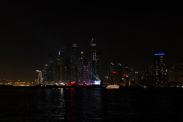 Beautiful night view of Dubai skyscrapers from the sea. Night panorama of Dubai Marina